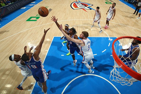 OKLAHOMA CITY, OK - NOVEMBER 25:  Tyrese Maxey #0 of the Philadelphia 76ers and Davis Bertans #9 of the Oklahoma City Thunder battle for a rebound during the game on November 25, 2023 at Paycom Arena in Oklahoma City, Oklahoma. NOTE TO USER: User expressly acknowledges and agrees that, by downloading and or using this photograph, User is consenting to the terms and conditions of the Getty Images License Agreement. Mandatory Copyright Notice: Copyright 2023 NBAE (Photo by Zach Beeker/NBAE via Getty Images)