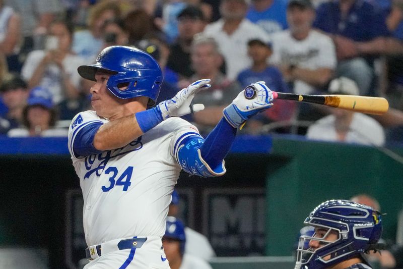 Jun 10, 2024; Kansas City, Missouri, USA; Kansas City Royals catcher Freddy Fermin (34) hits a one-run single against the New York Yankees in the eighth inning at Kauffman Stadium. Mandatory Credit: Denny Medley-USA TODAY Sports