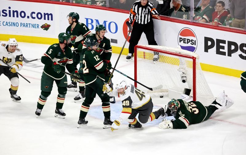 Apr 26, 2025; Saint Paul, Minnesota, USA; Vegas Golden Knights center Ivan Barbashev (49) puts the puck past Minnesota Wild goaltender Filip Gustavsson (32) during 1st OT in game four of the first round of the 2025 Stanley Cup Playoffs at Xcel Energy Center. Vegas Golden Knights win 4-3. Mandatory Credit: Bruce Fedyck-Imagn Images