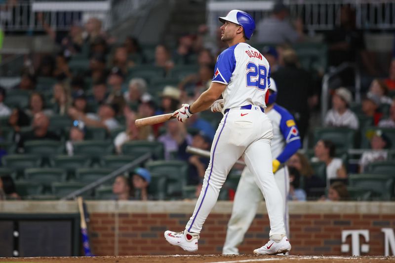 Aug 24, 2024; Atlanta, Georgia, USA; Atlanta Braves first baseman Matt Olson (28) hits a RBI double against the Washington Nationals in the sixth inning at Truist Park. Mandatory Credit: Brett Davis-USA TODAY Sports