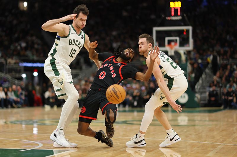 MILWAUKEE, WISCONSIN - APRIL 05: Javon Freeman-Liberty #0 of the Toronto Raptors is fouled by Pat Connaughton #24 of the Milwaukee Bucks during the first half of a game at Fiserv Forum on April 05, 2024 in Milwaukee, Wisconsin. NOTE TO USER: User expressly acknowledges and agrees that, by downloading and or using this photograph, User is consenting to the terms and conditions of the Getty Images License Agreement. (Photo by Stacy Revere/Getty Images)