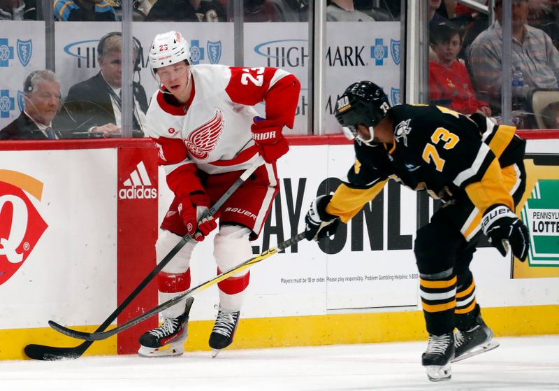 Apr 11, 2024; Pittsburgh, Pennsylvania, USA; Detroit Red Wings left wing Lucas Raymond (23) skates with the puck against Pittsburgh Penguins defenseman Pierre-Olivier Joseph (73) during the second period at PPG Paints Arena. Mandatory Credit: Charles LeClaire-USA TODAY Sports