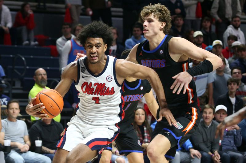 Jan 10, 2024; Oxford, Mississippi, USA; Mississippi Rebels forward Jaemyn Brakefield (4) drives to the basket as Florida Gators center Micah Handlogten (3) defends during the second half at The Sandy and John Black Pavilion at Ole Miss. Mandatory Credit: Petre Thomas-USA TODAY Sports