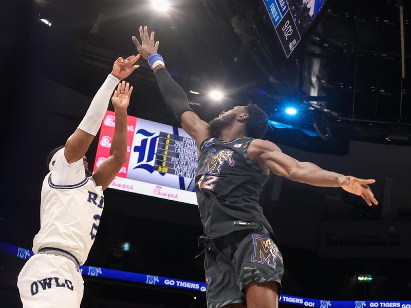 Feb 26, 2025; Memphis, Tennessee, USA; Rice Owls guard Emory Lanier (2) shoots against Memphis Tigers center Moussa Cisse (32) during the first half at FedExForum. Mandatory Credit: Wesley Hale-Imagn Images