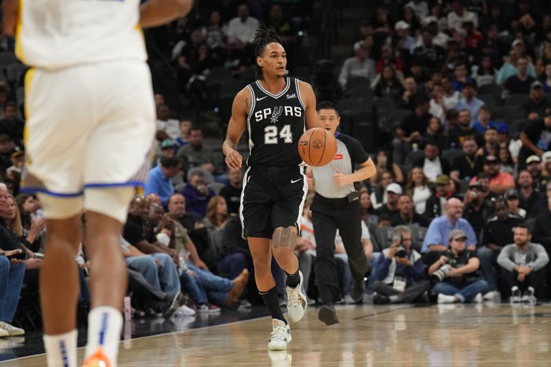 SAN ANTONIO, TX - MARCH 11: Devin Vassell #24 of the San Antonio Spurs dribbles the ball during the game against the Golden State Warriors on March 11, 2024 at the AT&T Center in San Antonio, Texas. NOTE TO USER: User expressly acknowledges and agrees that, by downloading and or using this photograph, user is consenting to the terms and conditions of the Getty Images License Agreement. Mandatory Copyright Notice: Copyright 2024 NBAE (Photos by Jesse D. Garrabrant/NBAE via Getty Images)