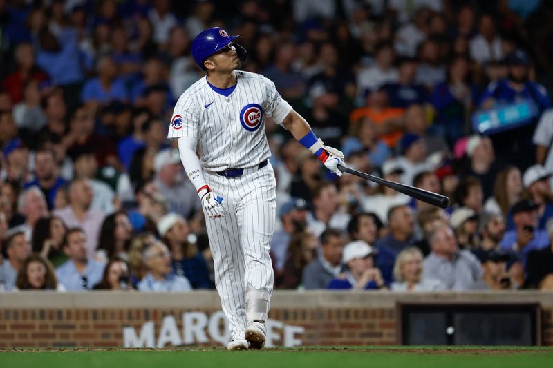 Sep 19, 2024; Chicago, Illinois, USA; Chicago Cubs outfielder Seiya Suzuki (27) hits a two-run home run against the Washington Nationals during the third inning at Wrigley Field. Mandatory Credit: Kamil Krzaczynski-Imagn Images