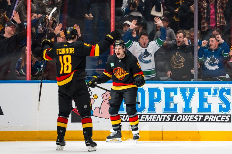 Jan 23, 2026; Vancouver, British Columbia, CAN; Vancouver Canucks forward Drew O'Connor (18) and forward Teddy Blueger (53) celebrate Blueger’s goal against the New Jersey Devils in the second period at Rogers Arena. Mandatory Credit: Bob Frid-Imagn Images