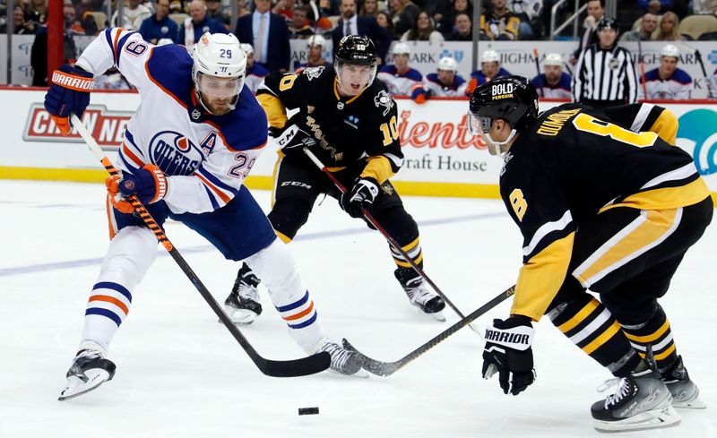 Feb 23, 2023; Pittsburgh, Pennsylvania, USA;  Edmonton Oilers center Leon Draisaitl (29) skates with the puck against Pittsburgh Penguins left wing Drew O'Connor (10) and defenseman Brian Dumoulin (8) during the second period at PPG Paints Arena. Mandatory Credit: Charles LeClaire-USA TODAY Sports