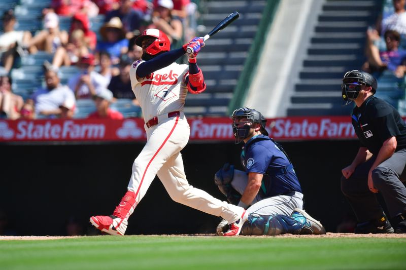 Jul 14, 2024; Anaheim, California, USA; Los Angeles Angels right fielder Jo Adell (7) hits a three run home run against the Seattle Mariners during the eighth inning at Angel Stadium. Mandatory Credit: Gary A. Vasquez-USA TODAY Sports