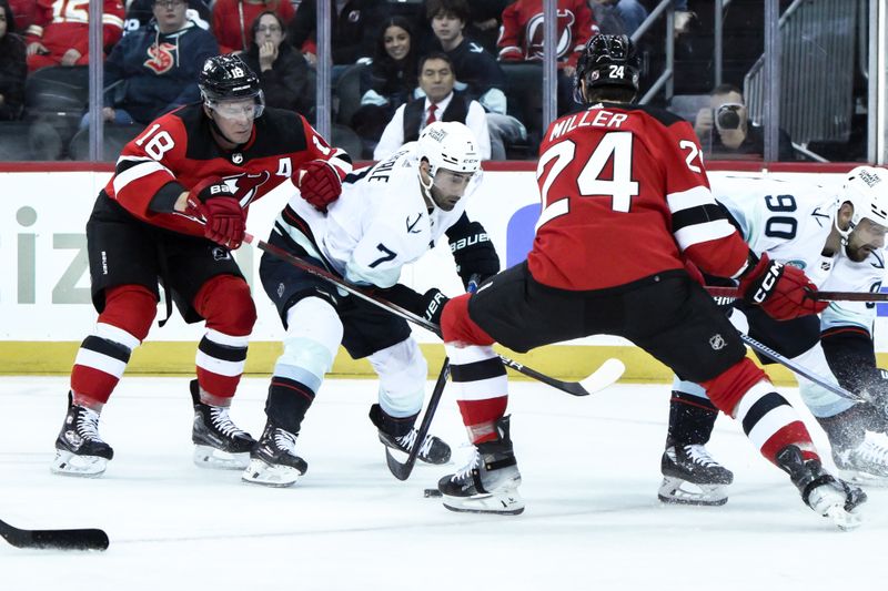 Feb 12, 2024; Newark, New Jersey, USA; Seattle Kraken right wing Jordan Eberle (7) skates with the puck while being defended by New Jersey Devils left wing Ondrej Palat (18) and New Jersey Devils defenseman Colin Miller (24) during the first period at Prudential Center. Mandatory Credit: John Jones-USA TODAY Sports