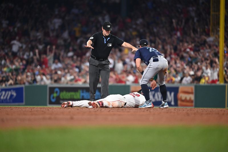 Jul 30, 2024; Boston, Massachusetts, USA; Boston Red Sox right fielder Wilyer Abreu (52) slides into second base safe against Seattle Mariners third baseman Dylan Moore (25) during the fifth inning at Fenway Park. Mandatory Credit: Eric Canha-USA TODAY Sports