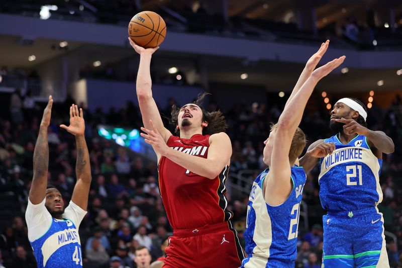 MILWAUKEE, WISCONSIN - FEBRUARY 13: Jaime Jaquez Jr. #11 of the Miami Heat drives to the basket against AJ Green #20 of the Milwaukee Bucks during the second half of a game at Fiserv Forum on February 13, 2024 in Milwaukee, Wisconsin. NOTE TO USER: User expressly acknowledges and agrees that, by downloading and or using this photograph, User is consenting to the terms and conditions of the Getty Images License Agreement. (Photo by Stacy Revere/Getty Images)