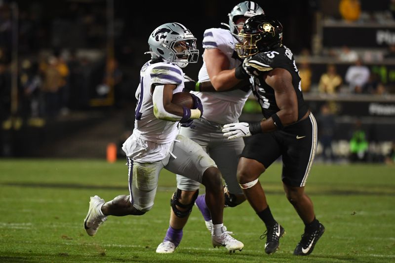 Oct 12, 2024; Boulder, Colorado, USA; Kansas State Wildcats running back DJ Giddens (31) runs for a short gain during the second half against the Colorado Buffaloes at Folsom Field. Mandatory Credit: Christopher Hanewinckel-Imagn Images
