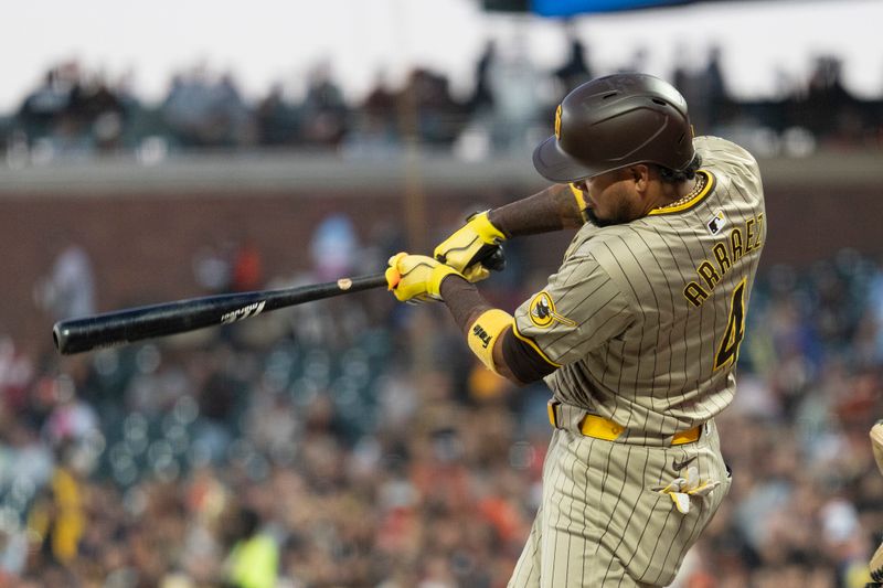 Sep 13, 2024; San Francisco, California, USA;  San Diego Padres first base Luis Arraez (4) hits a single during the first inning against the San Francisco Giants at Oracle Park. Mandatory Credit: Stan Szeto-Imagn Images