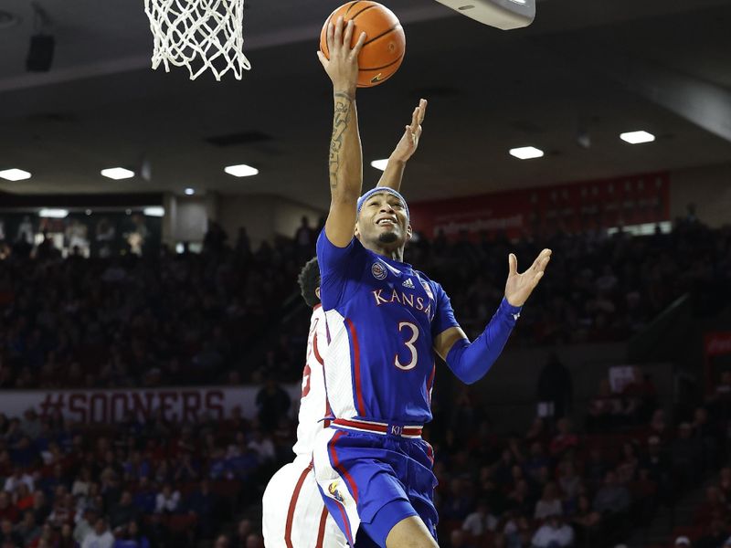 Feb 11, 2023; Norman, Oklahoma, USA; Kansas Jayhawks guard Dajuan Harris Jr. (3) goes up for a basket in front of Oklahoma Sooners guard Grant Sherfield (25) during the first half at Lloyd Noble Center. Mandatory Credit: Alonzo Adams-USA TODAY Sports