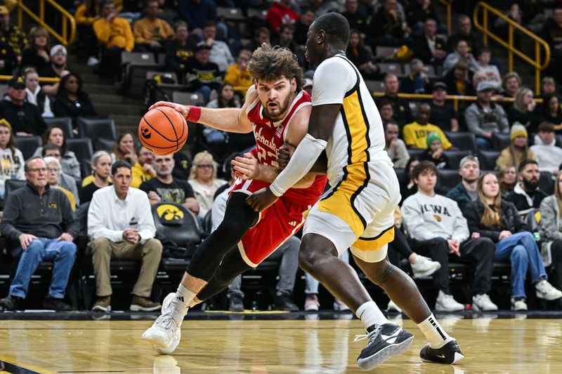 Jan 7, 2025; Iowa City, Iowa, USA; Nebraska Cornhuskers forward Andrew Morgan (23) goes to the basket as Iowa Hawkeyes forward Ladji Dembele (13) defends during the first half at Carver-Hawkeye Arena. Mandatory Credit: Jeffrey Becker-Imagn Images