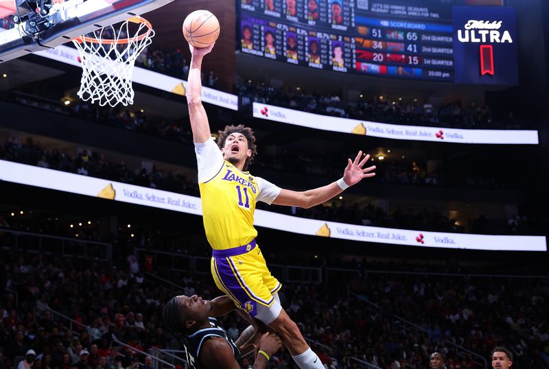 ATLANTA, GEORGIA - JANUARY 30:  Jaxson Hayes #11 of the Los Angeles Lakers is charged with an offensive foul as he attempts to dunk over Clint Capela #15 of the Atlanta Hawks during the second quarter at State Farm Arena on January 30, 2024 in Atlanta, Georgia.  NOTE TO USER: User expressly acknowledges and agrees that, by downloading and/or using this photograph, user is consenting to the terms and conditions of the Getty Images License Agreement.  (Photo by Kevin C. Cox/Getty Images). (Photo by Kevin C. Cox/Getty Images)