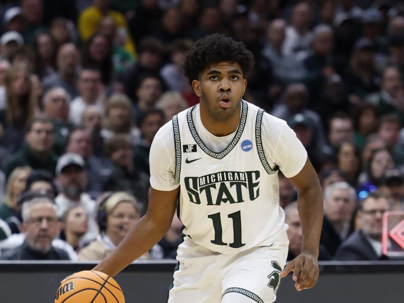 Mar 23, 2025; Cleveland, OH, USA; Michigan State Spartans guard Jase Richardson (11) dribbles in the first half against the Michigan State Spartans during the NCAA Tournament Second Round at Rocket Arena. Mandatory Credit: Rick Osentoski-Imagn Images