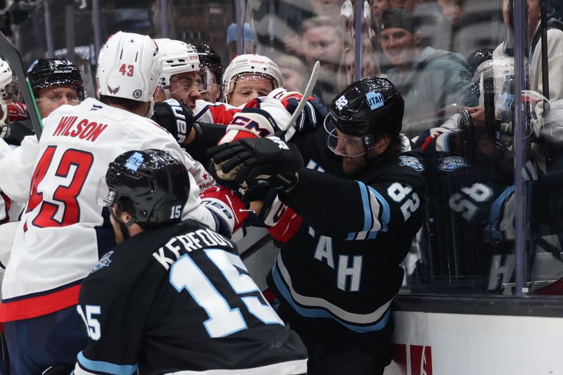 Nov 18, 2024; Salt Lake City, Utah, USA; Washington Capitals center Dylan Strome (17) and Utah Hockey Club center Logan Cooley (92) fight during the second period at Delta Center. Mandatory Credit: Rob Gray-Imagn Images