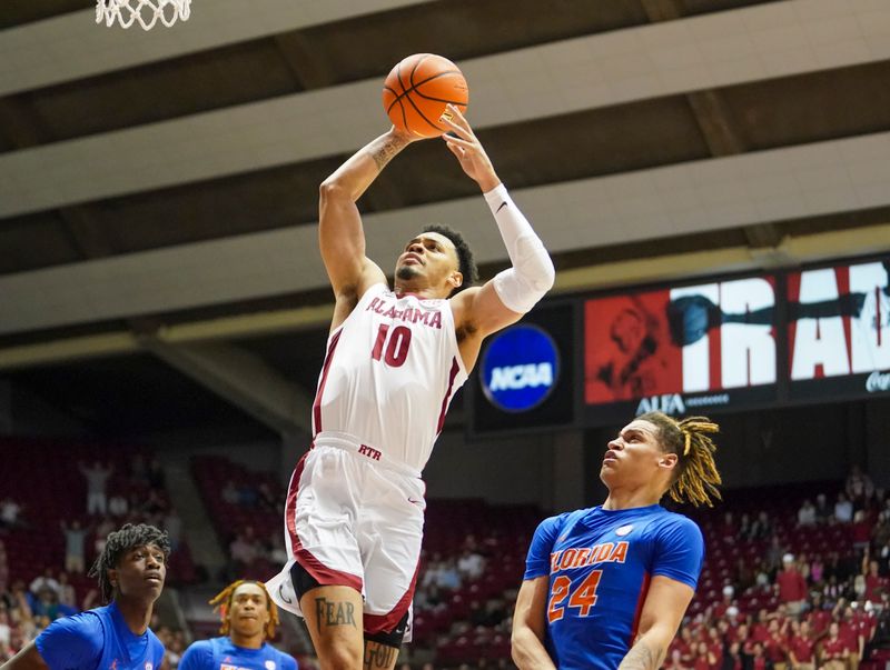 Feb 8, 2023; Tuscaloosa, Alabama, USA; Alabama Crimson Tide guard Dominick Welch (10) goes to the basket against Florida Gators guard Riley Kugel (24) during the second half at Coleman Coliseum. Mandatory Credit: Marvin Gentry-USA TODAY Sports