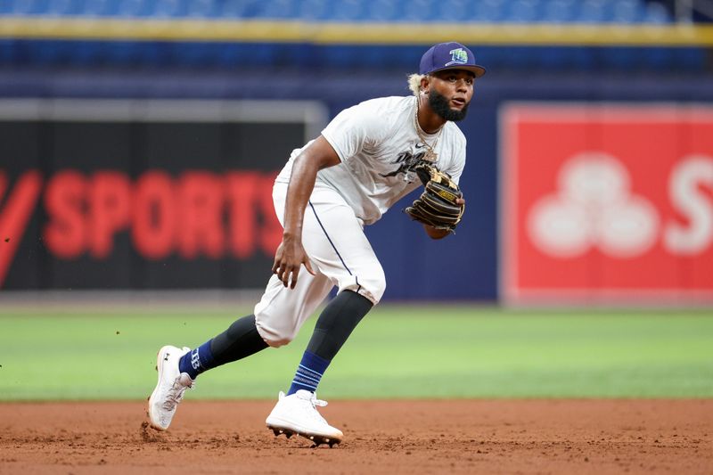 Aug 13, 2024; St. Petersburg, Florida, USA; Tampa Bay Rays third baseman Junior Caminero (13) takes fielding practice before a game against the Houston Astros at Tropicana Field. Mandatory Credit: Nathan Ray Seebeck-USA TODAY Sports