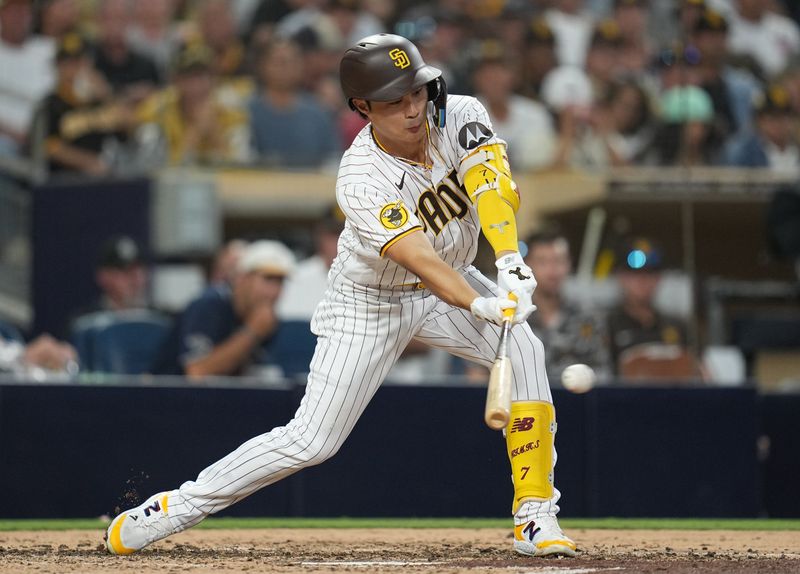 Jul 25, 2023; San Diego, California, USA; San Diego Padres second baseman Ha-Seong Kim (7) hits a single during the fifth inning against the Pittsburgh Pirates at Petco Park. Mandatory Credit: Ray Acevedo-USA TODAY Sports