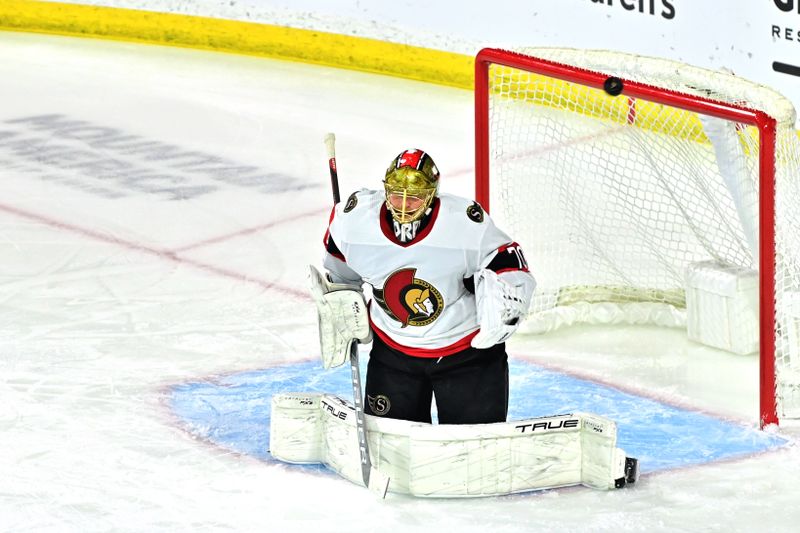 Dec 19, 2023; Tempe, Arizona, USA; The puck hits the crossbar as Ottawa Senators goaltender Joonas Korpisalo (70) defends in the first period against the Arizona Coyotes at Mullett Arena. Mandatory Credit: Matt Kartozian-USA TODAY Sports