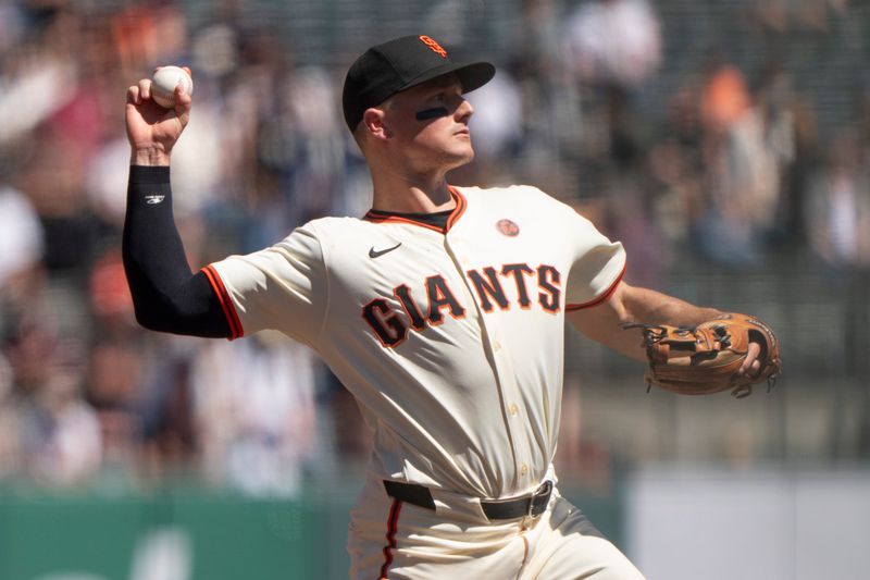 Sep 5, 2024; San Francisco, California, USA;  San Francisco Giants third base Matt Chapman (26) throws the ball during the fourth inning against the Arizona Diamondbacks at Oracle Park. Mandatory Credit: Stan Szeto-Imagn Images