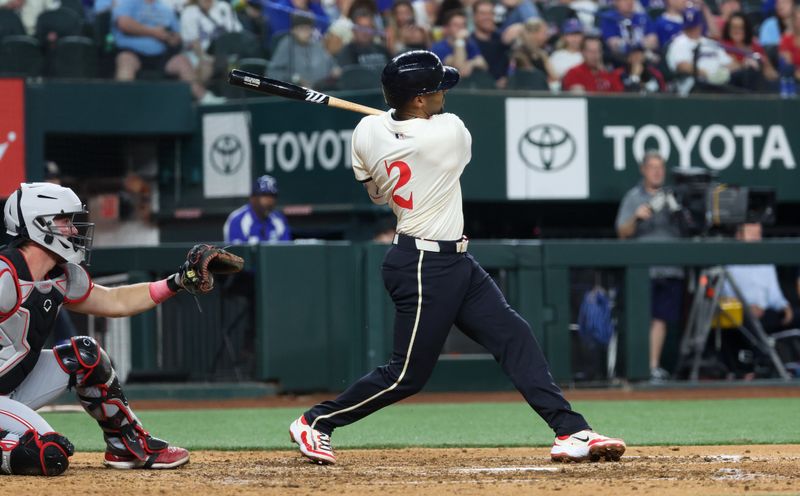 Apr 26, 2024; Arlington, Texas, USA;  Texas Rangers second baseman Marcus Semien (2) hits a home run during the eighth inning against the Cincinnati Reds at Globe Life Field. Mandatory Credit: Kevin Jairaj-USA TODAY Sports