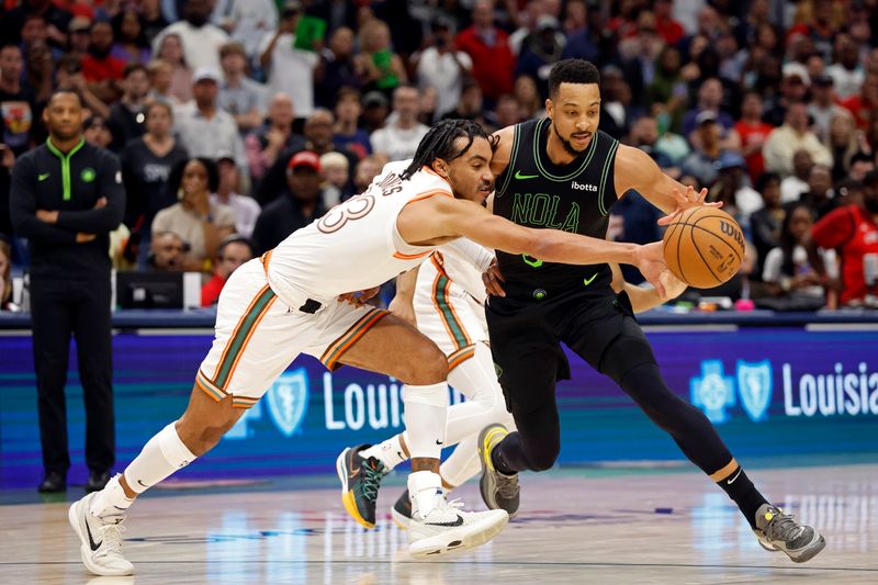 NEW ORLEANS, LOUISIANA - APRIL 05: CJ McCollum of the New Orleans Pelicans #3 and Tre Jones #33 of the San Antonio Spurs fight for a loose ball during the second half of an NBA game at Smoothie King Center on April 05, 2024 in New Orleans, Louisiana. NOTE TO USER: User expressly acknowledges and agrees that, by downloading and or using this photograph, User is consenting to the terms and conditions of the Getty Images License Agreement. (Photo by Tyler Kaufman/Getty Images)