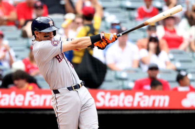 Sep 15, 2024; Anaheim, California, USA;  Houston Astros third baseman Mauricio Dubon (21) hits an RBI single during the fourth inning against the Los Angeles Angels at Angel Stadium. Mandatory Credit: Kiyoshi Mio-Imagn Images