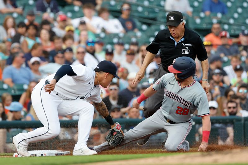 Jun 12, 2024; Detroit, Michigan, USA;  Detroit Tigers third baseman Gio Urshela (13) tags Washington Nationals right fielder Lane Thomas (28) out trying to steal third in the third inning at Comerica Park. Mandatory Credit: Rick Osentoski-USA TODAY Sports