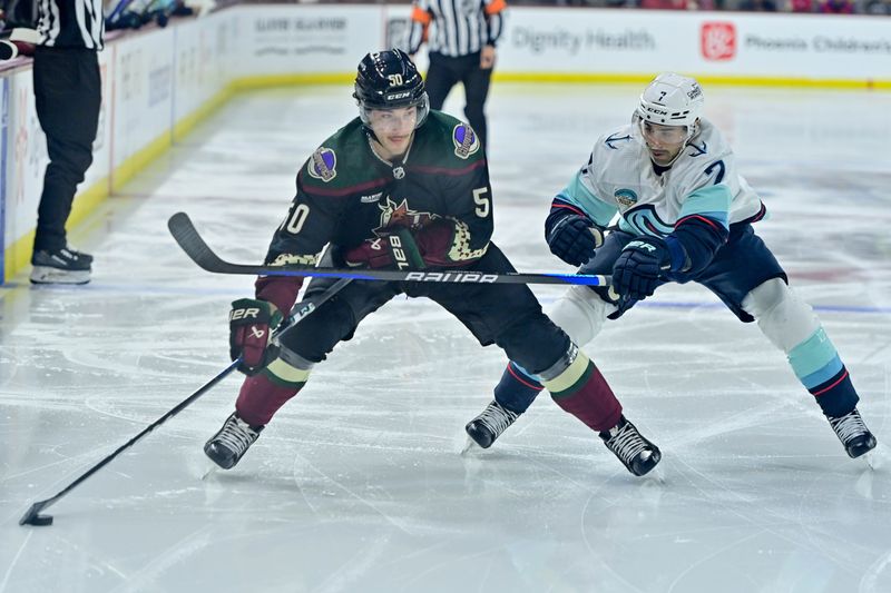 Nov 7, 2023; Tempe, Arizona, USA; Arizona Coyotes defenseman Sean Durzi (50) carries the puck as Seattle Kraken right wing Jordan Eberle (7) defends in the second period at Mullett Arena. Mandatory Credit: Matt Kartozian-USA TODAY Sports