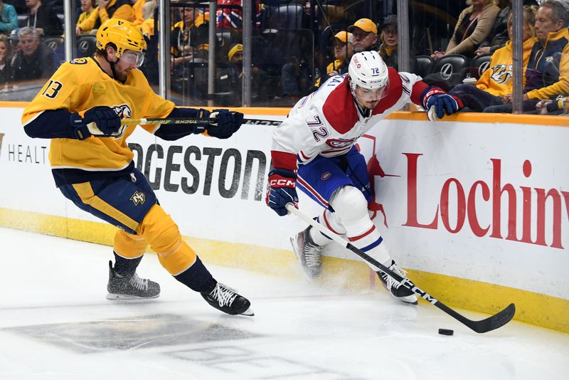 Mar 5, 2024; Nashville, Tennessee, USA; Montreal Canadiens defenseman Arber Xhekaj (72) handles the puck as he is defended by Nashville Predators center Yakov Trenin (13) during the first period at Bridgestone Arena. Mandatory Credit: Christopher Hanewinckel-USA TODAY Sports