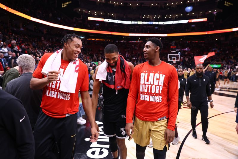 TORONTO, CANADA - FEBRUARY 22: Scottie Barnes #4 and RJ Barrett #9 of the Toronto Raptors talk with Mikal Bridges #1 of the Brooklyn Nets after the game on February 22, 2024 at the Scotiabank Arena in Toronto, Ontario, Canada.  NOTE TO USER: User expressly acknowledges and agrees that, by downloading and or using this Photograph, user is consenting to the terms and conditions of the Getty Images License Agreement.  Mandatory Copyright Notice: Copyright 2024 NBAE (Photo by Vaughn Ridley/NBAE via Getty Images)