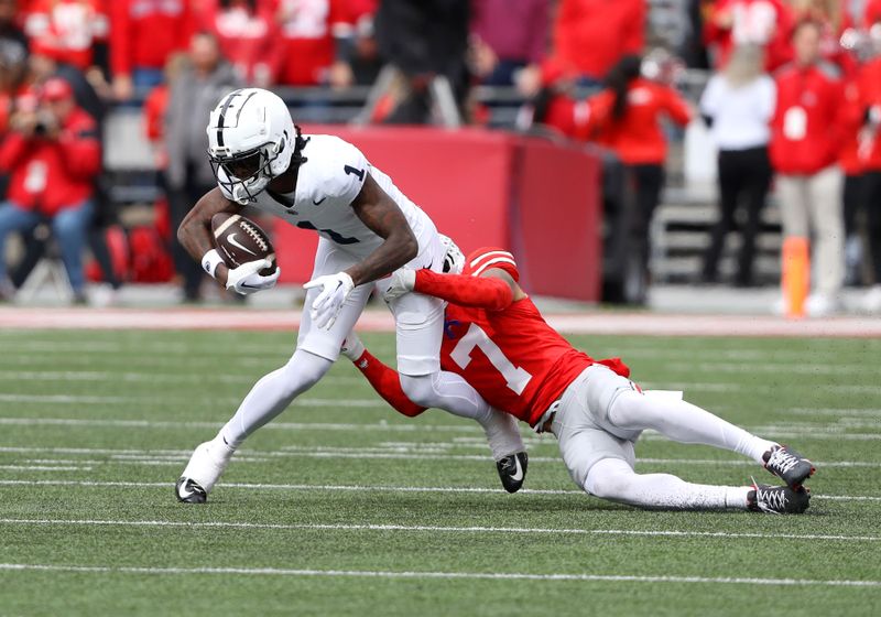 Oct 21, 2023; Columbus, Ohio, USA; Ohio State Buckeyes cornerback Jordan Hancock (7) tackles Penn State Nittany Lions wide receiver KeAndre Lambert-Smith (1) during the third quarter at Ohio Stadium. Mandatory Credit: Joseph Maiorana-USA TODAY Sports