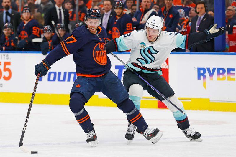 Jan 18, 2024; Edmonton, Alberta, CAN; Seattle Kraken defensemen Will Borgen (3) tries to pull Edmonton Oilers forward Connor McDavid (97) off the puck during the first period at Rogers Place. Mandatory Credit: Perry Nelson-USA TODAY Sports