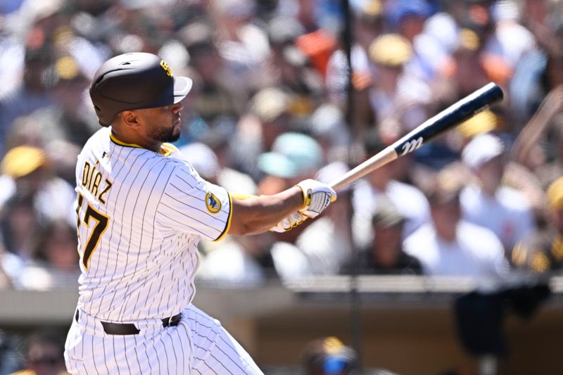 Apr 30, 2025; San Diego, California, USA; San Diego Padres catcher Elias Diaz (17) hits a solo home run during the third inning against the San Francisco Giants at Petco Park. Adames was out on the play. Mandatory Credit: Denis Poroy-Imagn Images