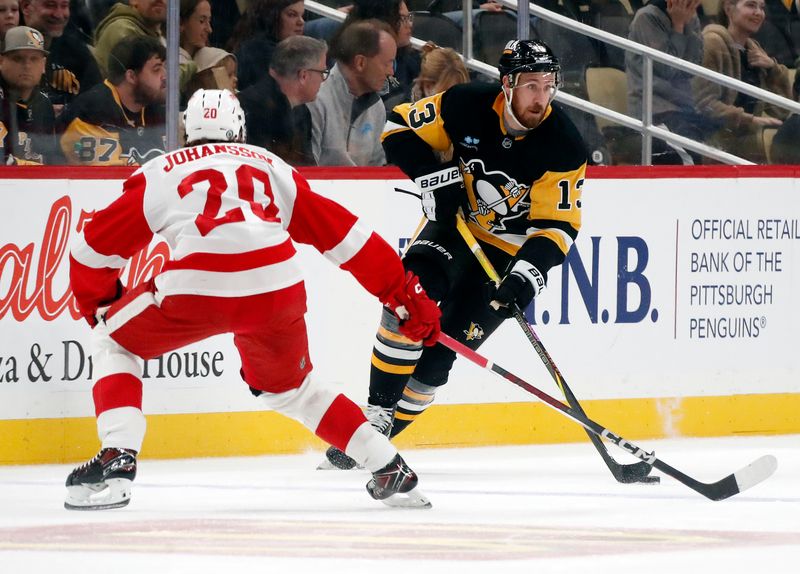 Oct 1, 2024; Pittsburgh, Pennsylvania, USA;  Pittsburgh Penguins right wing Kevin Hayes (13) moves the puck as Detroit Red Wings defenseman Albert Johansson (20) defends during the first period at PPG Paints Arena. Mandatory Credit: Charles LeClaire-Imagn Images