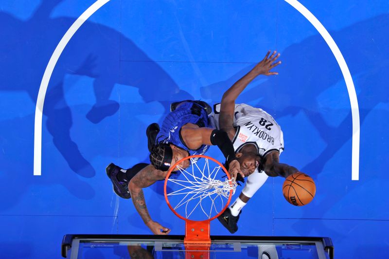 ORLANDO, FL - OCTOBER 25: Dorian Finney-Smith #28 of the Brooklyn Nets drives to the basket during the game against the Orlando Magic on October 25, 2024 at Kia Center in Orlando, Florida. NOTE TO USER: User expressly acknowledges and agrees that, by downloading and or using this photograph, User is consenting to the terms and conditions of the Getty Images License Agreement. Mandatory Copyright Notice: Copyright 2024 NBAE (Photo by Fernando Medina/NBAE via Getty Images)