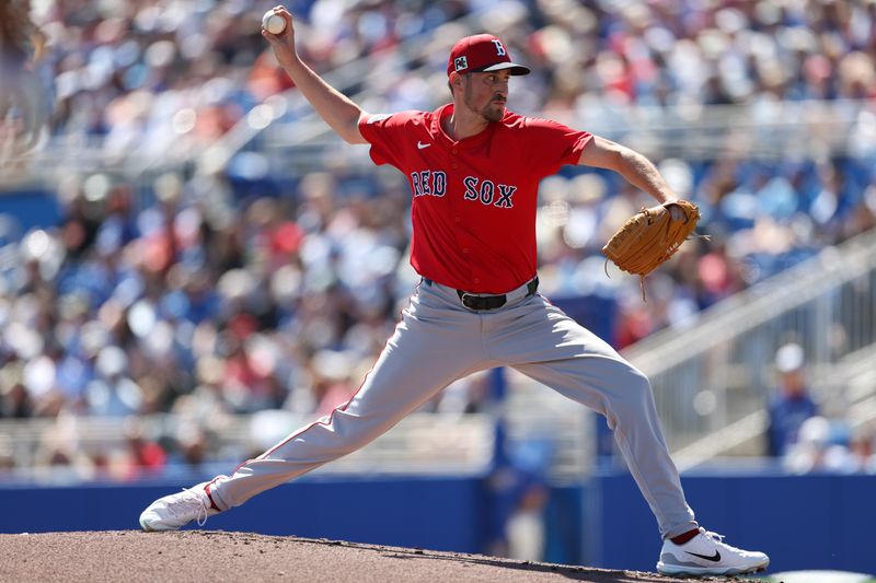 Mar 6, 2025; Dunedin, Florida, USA; Boston Red Sox pitcher Cooper Criswell (64) throws a pitch against the Toronto Blue Jays in the first inning during spring training at TD Ballpark. Mandatory Credit: Nathan Ray Seebeck-Imagn Images