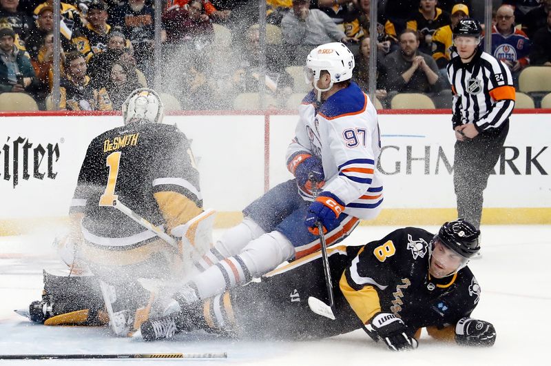 Feb 23, 2023; Pittsburgh, Pennsylvania, USA; Edmonton Oilers center Connor McDavid (97)is upended by Pittsburgh Penguins defenseman Brian Dumoulin (8) into Pens goaltender Casey DeSmith (1) during the third period at PPG Paints Arena. McDavid (97) was awarded a penalty shot as a result. Edmonton won 7-2. Mandatory Credit: Charles LeClaire-USA TODAY Sports