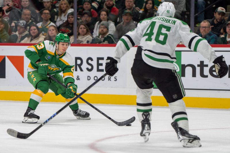 Nov 16, 2024; Saint Paul, Minnesota, USA; Minnesota Wild center Marco Rossi (23) skates with the puck against Dallas Stars defenseman Ilya Lyubushkin (46) in the first period at Xcel Energy Center. Mandatory Credit: Matt Blewett-Imagn Images