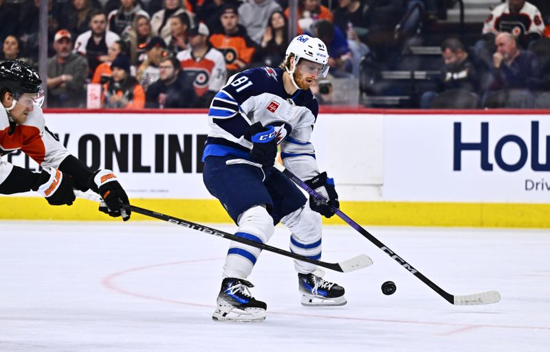 Feb 8, 2024; Philadelphia, Pennsylvania, USA; Winnipeg Jets left wing Kyle Connor (81) reaches for the puck against the Philadelphia Flyers in the second period at Wells Fargo Center. Mandatory Credit: Kyle Ross-USA TODAY Sports