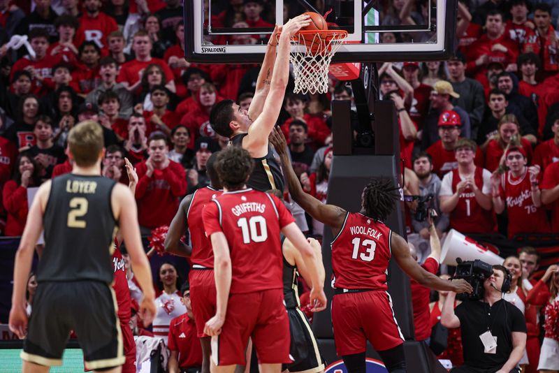 Jan 28, 2024; Piscataway, New Jersey, USA; Purdue Boilermakers center Zach Edey (15) dunks the ball in front of Rutgers Scarlet Knights forward Antwone Woolfolk (13) during the second half at Jersey Mike's Arena. Mandatory Credit: Vincent Carchietta-USA TODAY Sports