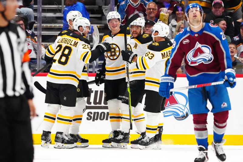 Oct 16, 2024; Denver, Colorado, USA; Boston Bruins right wing David Pastrnak (88) celebrates his goal with center Elias Lindholm (28), left wing Brad Marchand (63), and center Trent Frederic (11) in the second period against the Colorado Avalanche at Ball Arena. Mandatory Credit: Ron Chenoy-Imagn Images