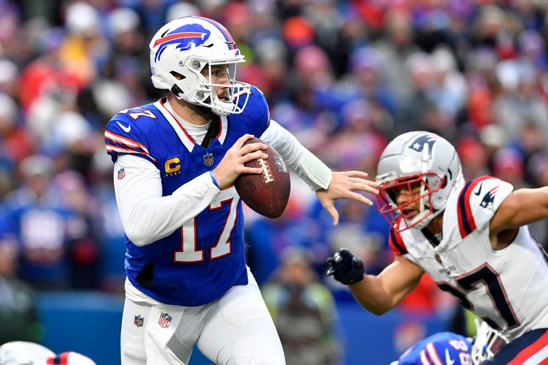 Buffalo Bills quarterback Josh Allen scrambles out of the pocket looking to pass under pressure by New England Patriots cornerback Myles Bryant, right, during the second half of an NFL football game in Orchard Park, N.Y., Sunday, Dec. 31, 2023. (AP Photo/Adrian Kraus)