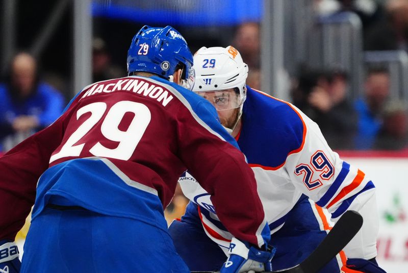 Nov 30, 2024; Denver, Colorado, USA; Colorado Avalanche center Nathan MacKinnon (29) and Edmonton Oilers center Leon Draisaitl (29) face off from each other in the first period at Ball Arena. Mandatory Credit: Ron Chenoy-Imagn Images