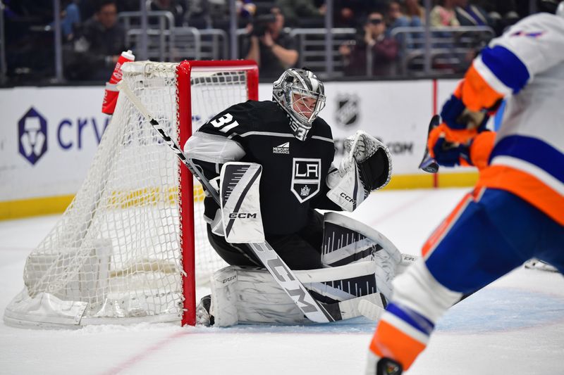 Mar 11, 2024; Los Angeles, California, USA; Los Angeles Kings goaltender David Rittich (31) blocks a shot against New York Islanders center Jean-Gabriel Pageau (44) during the third period at Crypto.com Arena. Mandatory Credit: Gary A. Vasquez-USA TODAY Sports