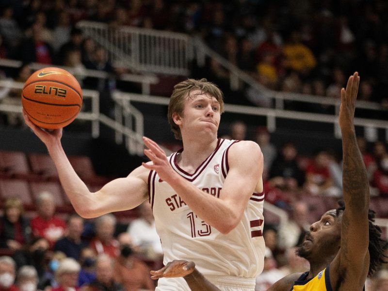 Jan 28, 2023; Stanford, California, USA; Stanford Cardinal guard Michael Jones (13) leaves his feet to pass over California Golden Bears guard Joel Brown (1) during the first half at Maples Pavilion. Mandatory Credit: D. Ross Cameron-USA TODAY Sports